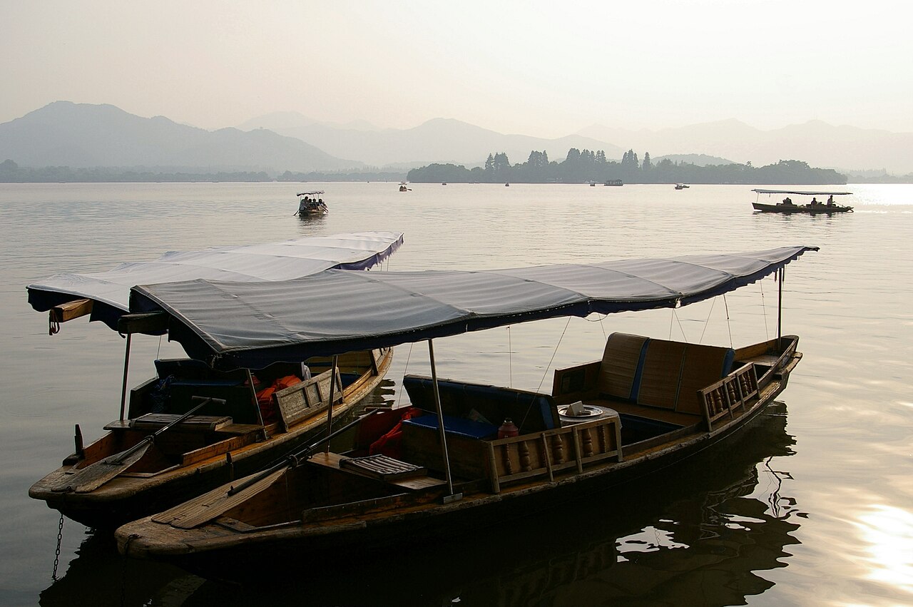 A boat and a long bridge on West Lake, Hangzhou